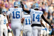 Detroit Lions wide receiver Amon-Ra St. Brown (14) celebrates with quarterback Jared Goff (16) after scoring a touchdown against the Minnesota Vikings during the second half of an NFL football game Sunday, Oct. 20, 2024 in Minneapolis. Detroit won 31-29. (AP Photo/Stacy Bengs)