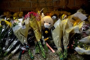 Dozens upon dozens of flowers are left at the base of the high school sign where a memorial was originally built one year ago the day of the Oxford High School shooting on Wednesday, Nov. 30, 2022 in Oxford. (Jake May | MLive.com)