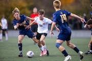 Byron Center junior Connor Jenks (16) goes for the ball during the division 1 boys soccer regional semifinals between Grand Haven and Byron Center at Grandville High School Grandville, Mich. on Tuesday, October 22, 2024. Byron Center won the game in a shootout, 2-1.