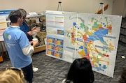 Residents inspect a possible new zoning plan for Ann Arbor as displayed at a public meeting at the downtown library on Oct. 23, 2024. (Ryan Stanton | MLive.com)