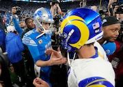 Detroit Lions quarterback Jared Goff (16) greets Los Angeles Rams quarterback Matthew Stafford after the second half of an NFL wild-card playoff football game, Sunday, Jan. 14, 2024, in Detroit. The Lions won 24-23. (AP Photo/Paul Sancya)