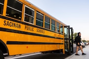 Students exit a bus during the first day of school at Saginaw United High School on Tuesday, Sept. 3, 2024. 