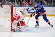Detroit Red Wings goaltender Alex Lyon protects the net from the New York Islanders' Anders Lee during the second period Tuesday. (AP Photo/Frank Franklin II)