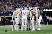 Detroit Lions offensive linesman including Frank Ragnow (77) Jonah Jackson (73) Taylor Decker (68) huddle during a plays call during an NFL football game against the Dallas Cowboys, Saturday, Dec. 30, 2023, in Arlington, Texas.