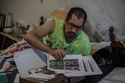 César Lepe looks at brain imaging done in August 2022, two years after his first COVID-19 infection. The PET-CT (full-body tomography) showed a decrease in metabolic activity in different areas of his brain. Jalisco, Mexico. December 6, 2022. Photo by Quetzalli Blanco