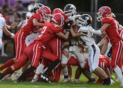 A Hanover-Horton runner is stacked up by the Grass Lake defense during a high school football game at the Hanover-Horton athletic complex on Friday, Sept. 13, 2024. Hanover-Horton won the game over Grass Lake, 49-21.