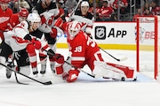 Detroit Red Wings goaltender CamTalbot deflects a shot from New Jersey Devils defenseman Brenden Dillon (5) during the first period Thursday. (AP Photo/Jose Juarez)