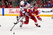 New York Rangers left wing Artemi Panarin battles with Detroit Red Wings defenseman Simon Edvinsson for the puck last Thursday. (AP Photo/Paul Sancya)