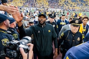 Michigan Wolverines head coach Sherrone Moore high-fies fans after Michigan football defeated the University of Southern California at Michigan Stadium in Ann Arbor on Saturday, Sept. 21, 2024.