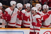 Detroit Red Wings center Dylan Larkin (71) celebrates his goal with teammates during the second period of an NHL hockey game against the Nashville Predators, Saturday, Oct. 19, 2024, in Nashville, Tenn. (AP Photo/George Walker IV)