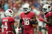Arizona Cardinals wide receiver Marvin Harrison Jr. (18) celebrates his touchdown catch against the Los Angeles Rams with Cardinals wide receivers Greg Dortch (4) and Zach Pascal (0) during the first half of an NFL football game Sunday, Sept. 15, 2024, in Glendale, Ariz. The Cardinals won 41-10. (AP Photo/Ross D. Franklin)