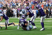 Minnesota Vikings quarterback Sam Darnold (14) is sacked by Detroit Lions linebacker Trevor Nowaske (53) during the second half of an NFL football game Sunday, Oct. 20, 2024 in Minneapolis. Detroit won 31-29. (AP Photo/Stacy Bengs)