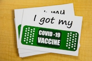"I got my COVID-19 vaccine" cards sit on a table at Bronson Methodist Hospital in downtown Kalamazoo, Michigan on Thursday, Dec. 17, 2020. (Joel Bissell | MLive.com) Joel Bissell | MLive.com