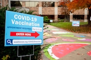 Signs guide visitors to the clinic entrance during a vaccine clinic for adults and children ages 5 to 11 at the Washtenaw County Health Department, 555 Towner St. in Ypsilanti on Tuesday, Nov. 9, 2021.