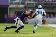 Minnesota Vikings linebacker Andrew Van Ginkel (43) tries to stop Detroit Lions running back Jahmyr Gibbs (26) during the first half of an NFL football game Sunday, Oct. 20, 2024 in Minneapolis. (AP Photo/Stacy Bengs)