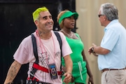 Muralist Okuda San Miguel smiles after signing the Shine Bright Saginaw Mural Project he created near 105 Lyon Street in Old Town Saginaw on Wednesday, June 12, 2024.
