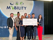 Gov. Gretchen Whitmer, right, presents a $100,000 check to the team at Civilized Cycles on Thursday, Oct. 24. (Photo provided by the Michigan Economic Development Corporation)