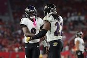 Baltimore Ravens quarterback Lamar Jackson (8) greets Baltimore Ravens running back Derrick Henry (22) after a touchdown during an NFL football game against the Tampa Bay Buccaneers, Monday, Oct. 21, 2024, in Tampa, Fla. (AP Photo/Peter Joneleit)