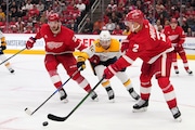 Detroit Red Wings defenseman Olli Maatta clears the puck as Nashville Predators center Tommy Novak puts on pressure last week. (AP Photo/Paul Sancya)