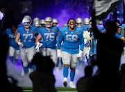 Detroit Lions offensive tackle Penei Sewell (58) runs on the field during introductions before an NFL football game against the Green Bay Packers Sunday, Nov. 23, 2023, in Detroit.