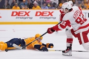 Detroit Red Wings center Marco Kasper shoots the puck past Nashville Predators defenseman Jeremy Lauzon during the third period Saturday. (AP Photo/George Walker IV)