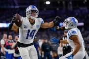Detroit Lions wide receiver Amon-Ra St. Brown (14) celebrates his touchdown catch with wide receiver Kalif Raymond during the second half of an NFL football game against the Dallas Cowboys, Saturday, Dec. 30, 2023, in Arlington, Texas. The Cowboys won 20-19. (AP Photo/Sam Hodde)