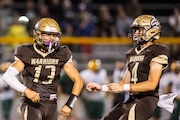 Bay City Western’s Mikey Deluca (13) celebrates with Bay City Western’s Dawson Lavender (4) during a football game at Bay City Western High School on Friday, Sept. 20, 2024.