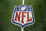 FILE - An NFL logo on the field after a football game between the Washington Redskins and Dallas Cowboys Sunday, Oct. 13, 2013, in Arlington, Texas. The NFL is making additional moves to reach more fans with direct-to-consumer offerings. The league announced on Wednesday, Aug. 9, 2023, that NFL Network and NFL RedZone will be available on “NFL+,” the streaming service the league launched last year. According to Nielsen’s cable estimates, NFL Network is available to 51.1 million customers, which is the most for a network run by a professional league or college conference.(AP Photo/LM Otero, File)