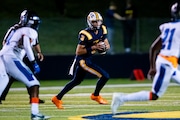 Saline’s Tommy Carr (3) runs with the ball looking for a pass during a high school football game between Saline and Ypsilanti Lincoln at Saline High School in Saline on Friday, Oct. 11, 2024. Saline defeated Ypsilanti Lincoln 42-0.